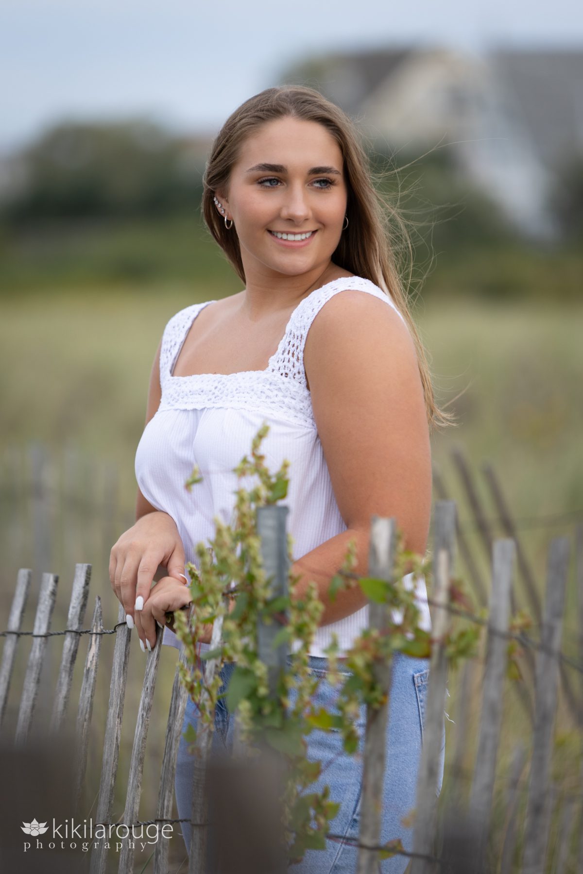 Triton Senior Portrait Girl in Jeans with white top tied in back at Plum Island dunes