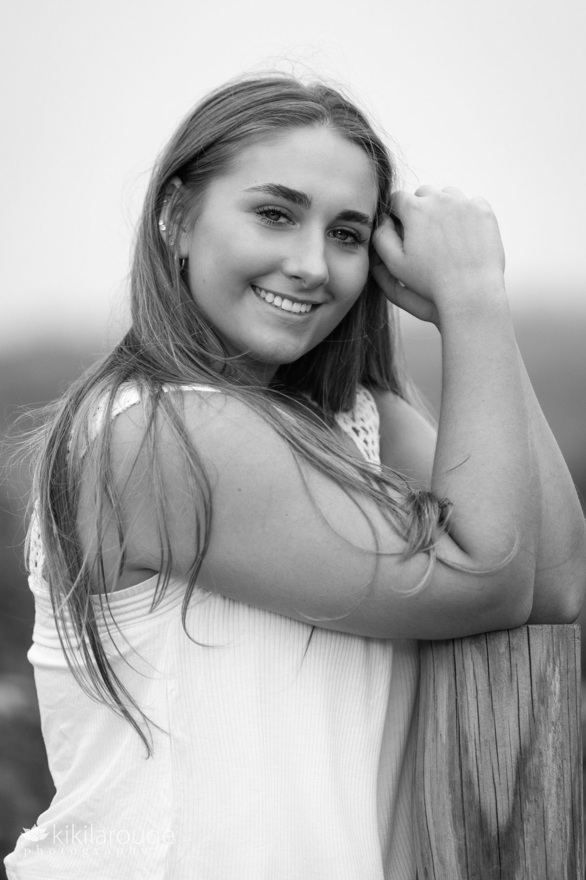 Triton Senior Portrait Girl in Jeans with white top tied in back at beach in Black and white