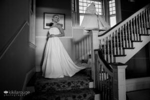 Bride in spotlight at the stairs landing at Eastern Point Yacht Club Gloucester