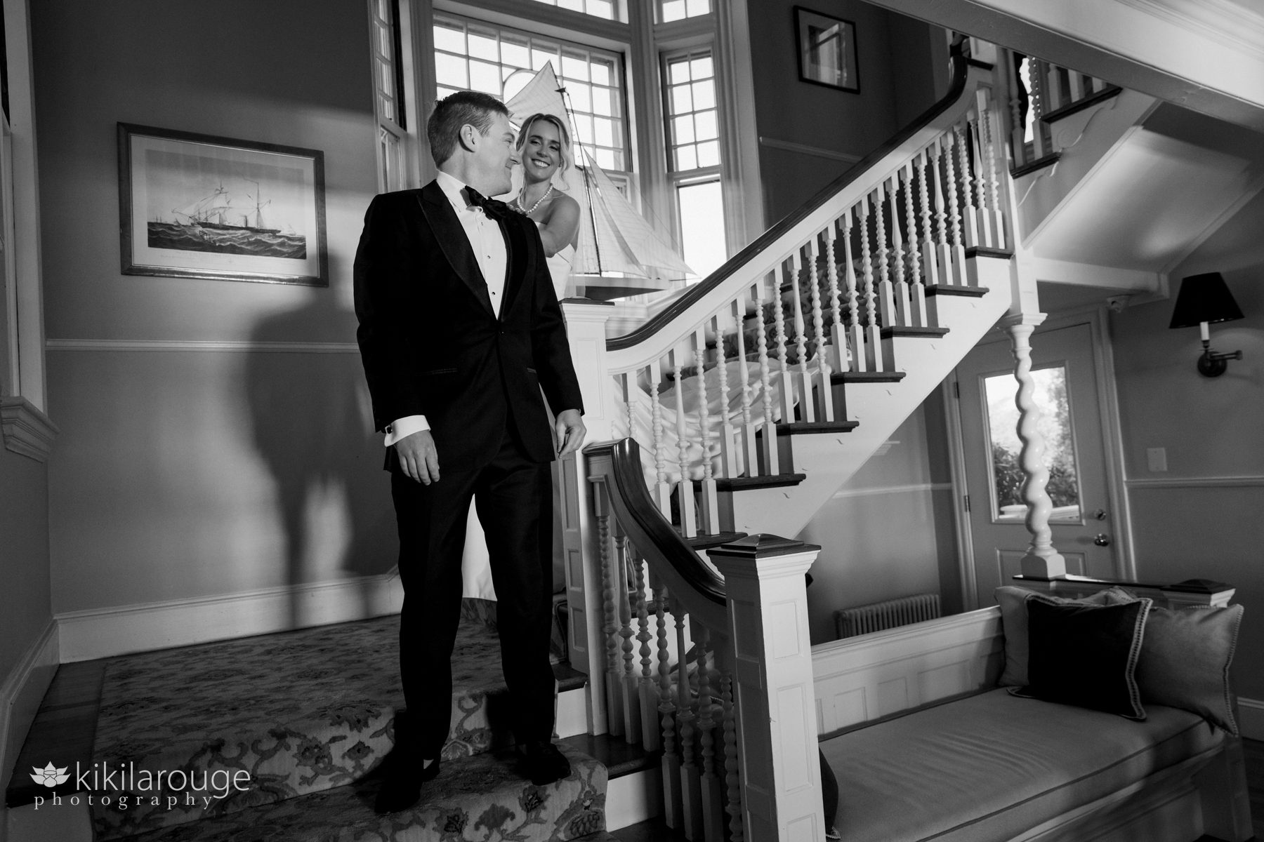 BW bride coming down yacht club stairs tapping groom for their first look