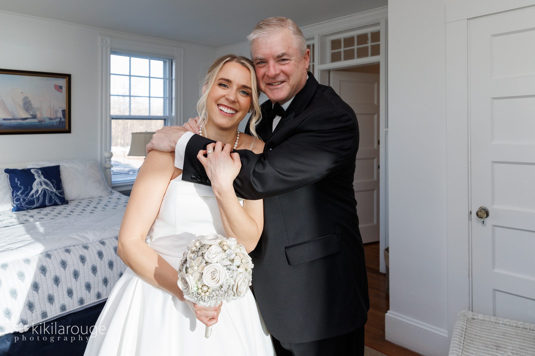 Dad hugging daughter in wedding gown