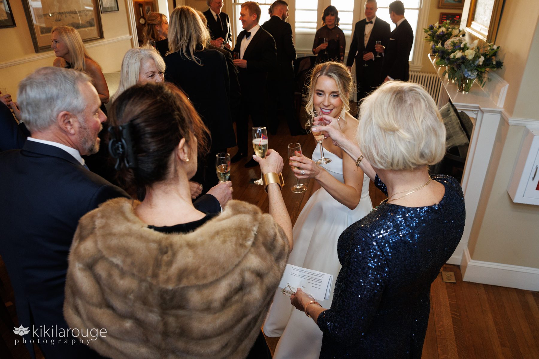 Bride toasting with champagne with her family