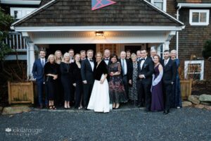 Formal group portrait of twenty people celebrating a wedding at Eastern Point Yacht Club Gloucester