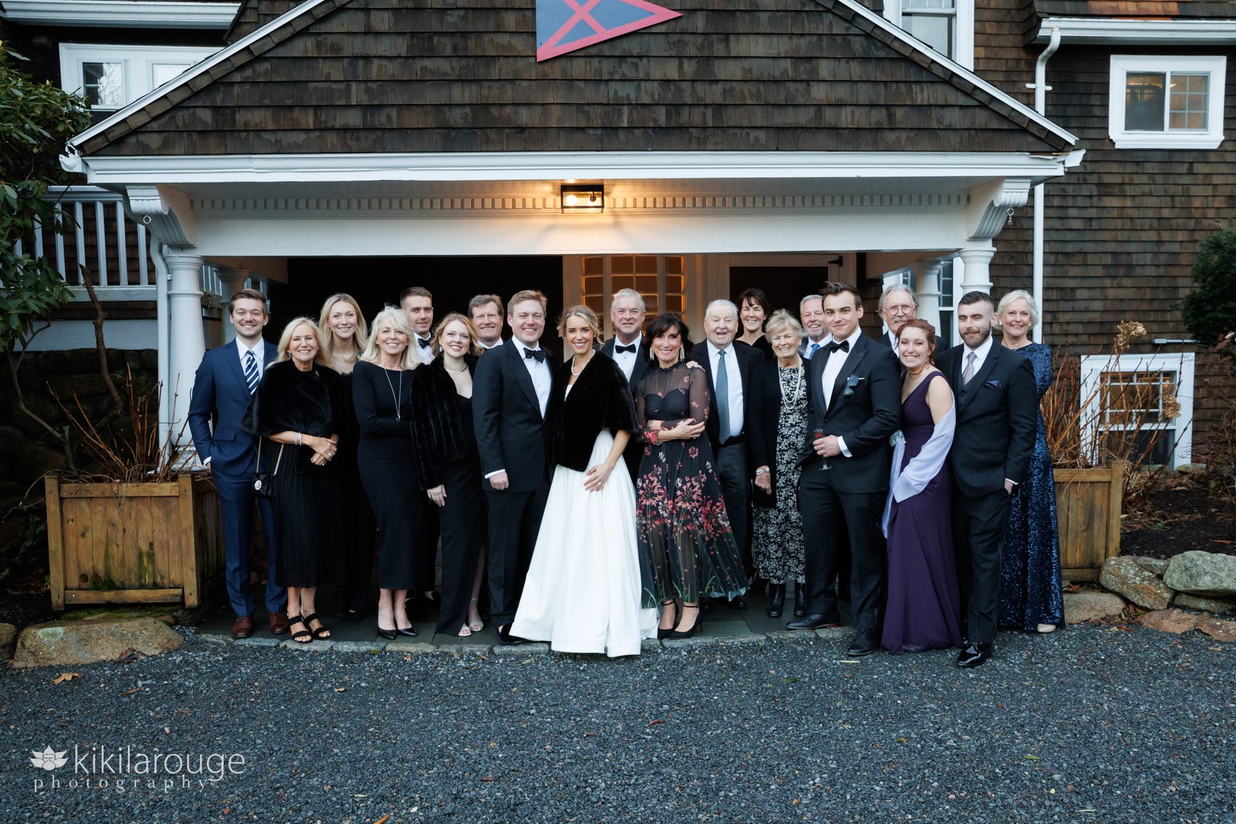 Formal group portrait of twenty people celebrating a wedding at Eastern Point Yacht Club Gloucester