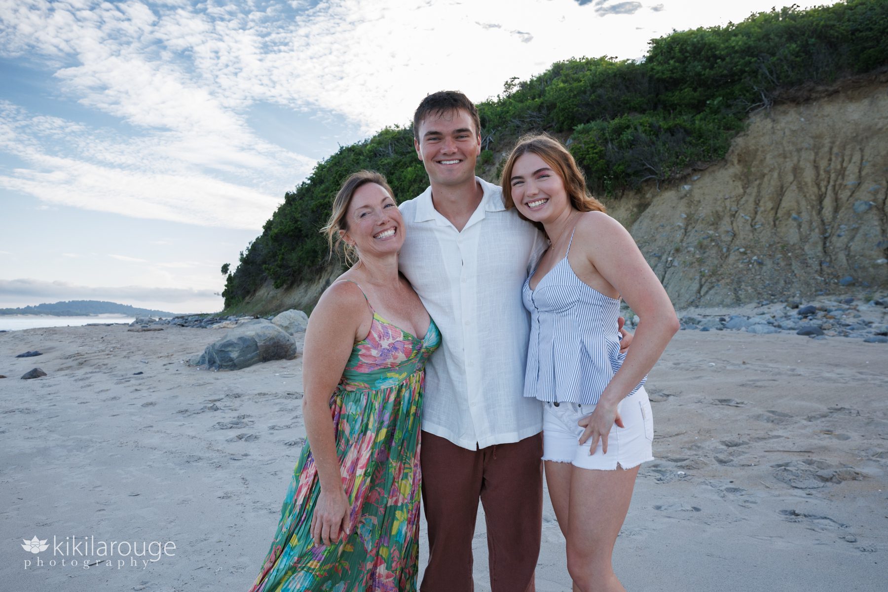 Mom with her son and daughter at Sandy Point beach in green floral dress