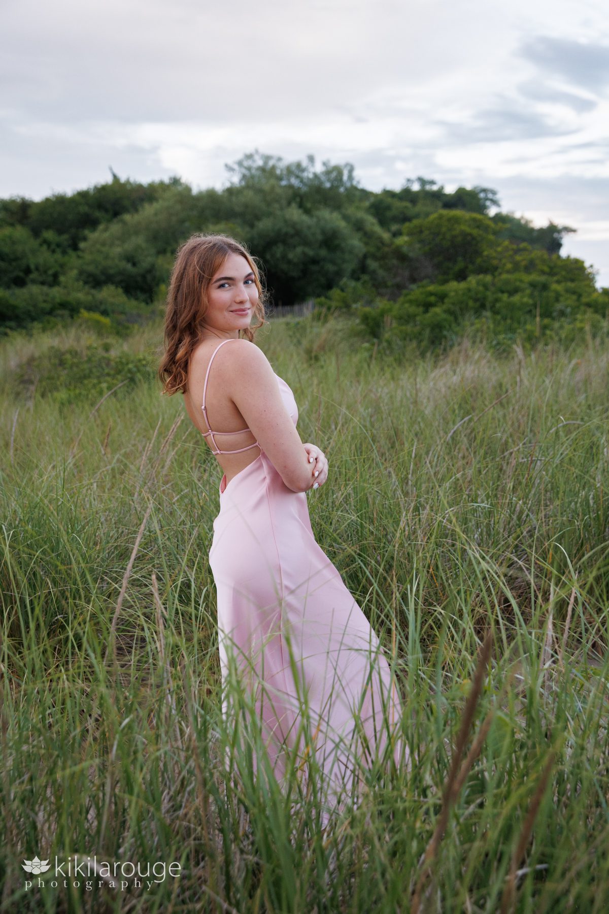 Girl in long pink dress in beach dunes at Sandy Point