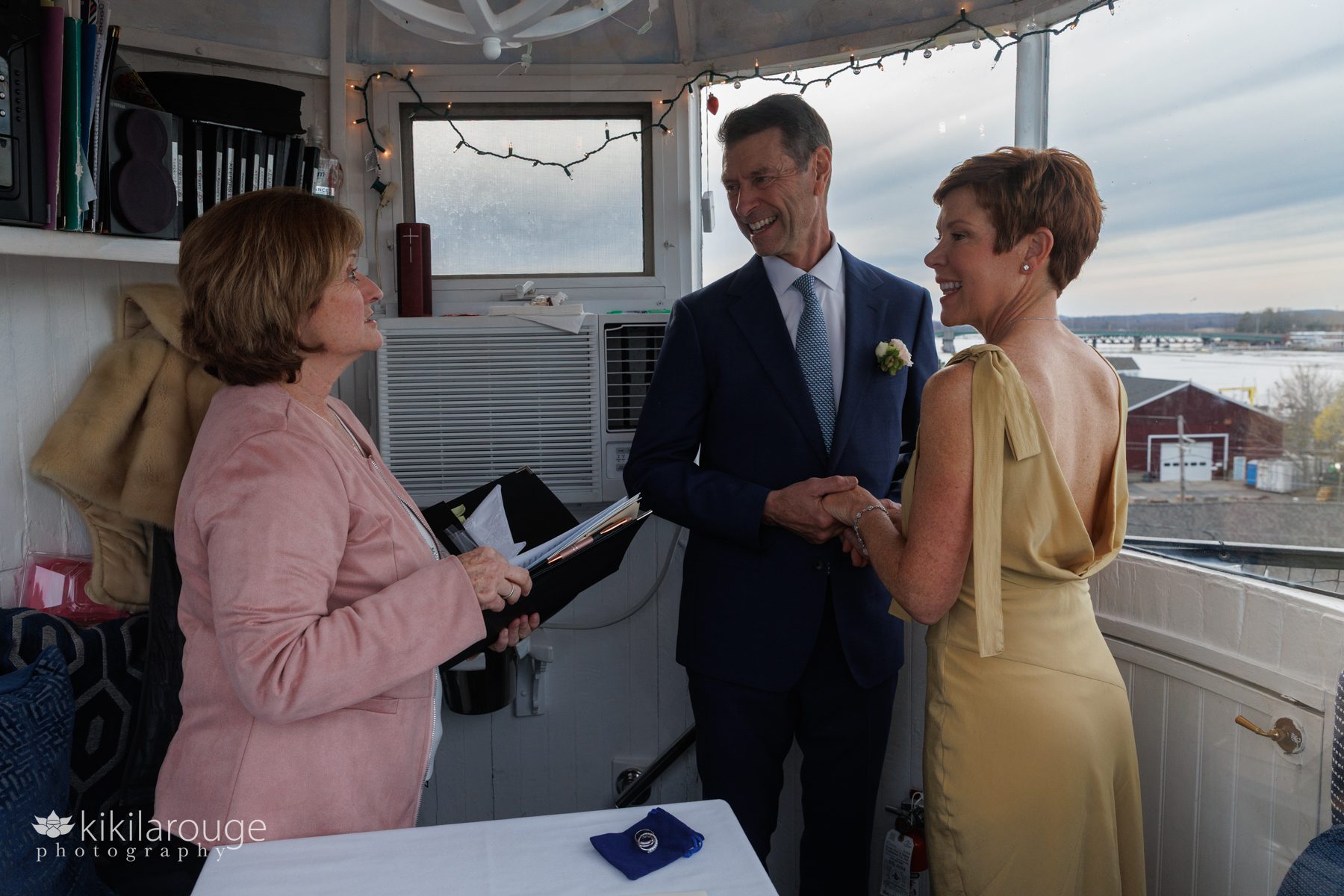 Woman in pink marrying couple atop the Newburyport Lighthouse
