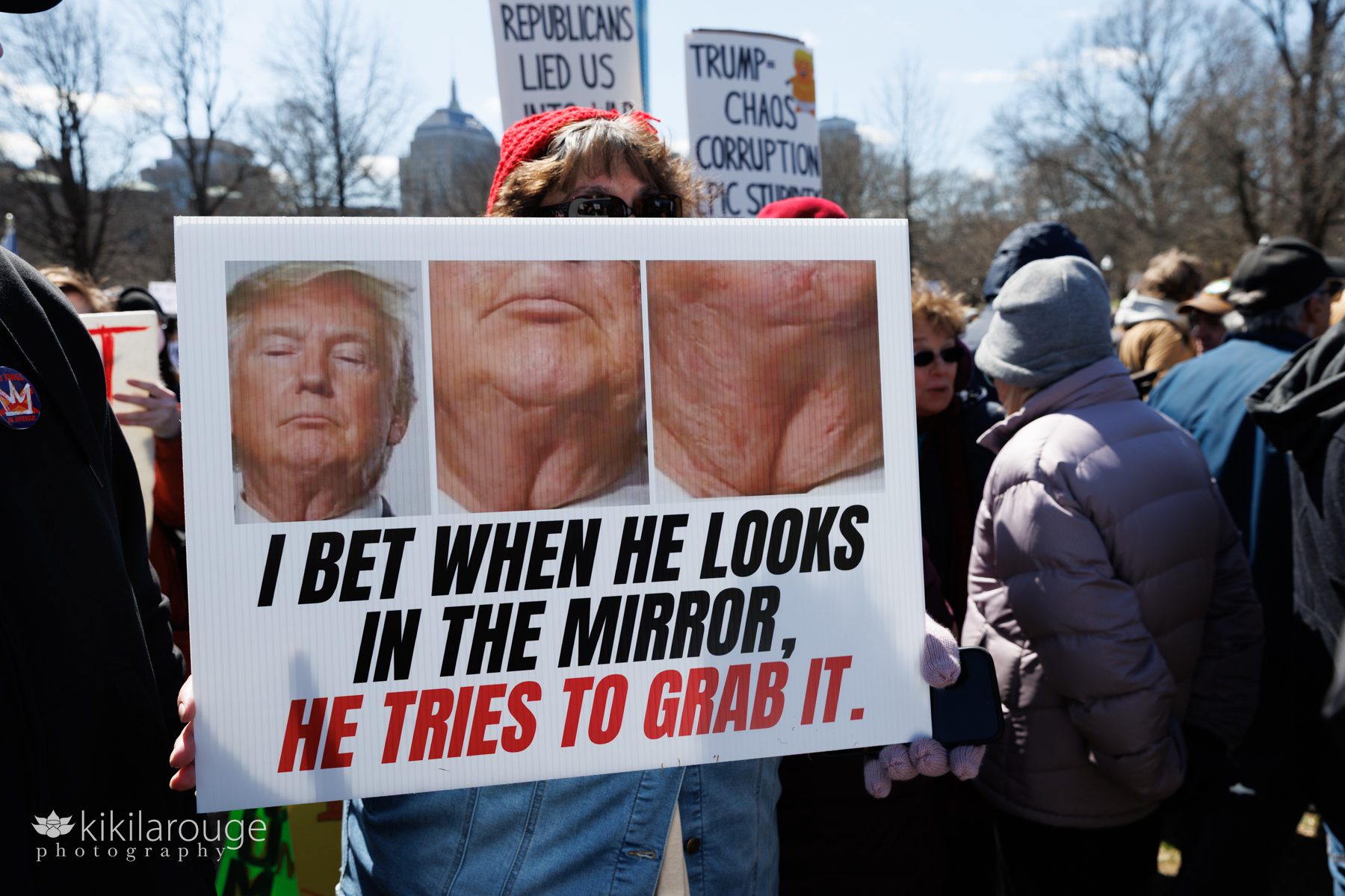 Close up photo of Trump's chicken neck that reads "I Bet When He Looks in the Mirror, He Tries to Grab It" No Kings protest signs on the Boston Common