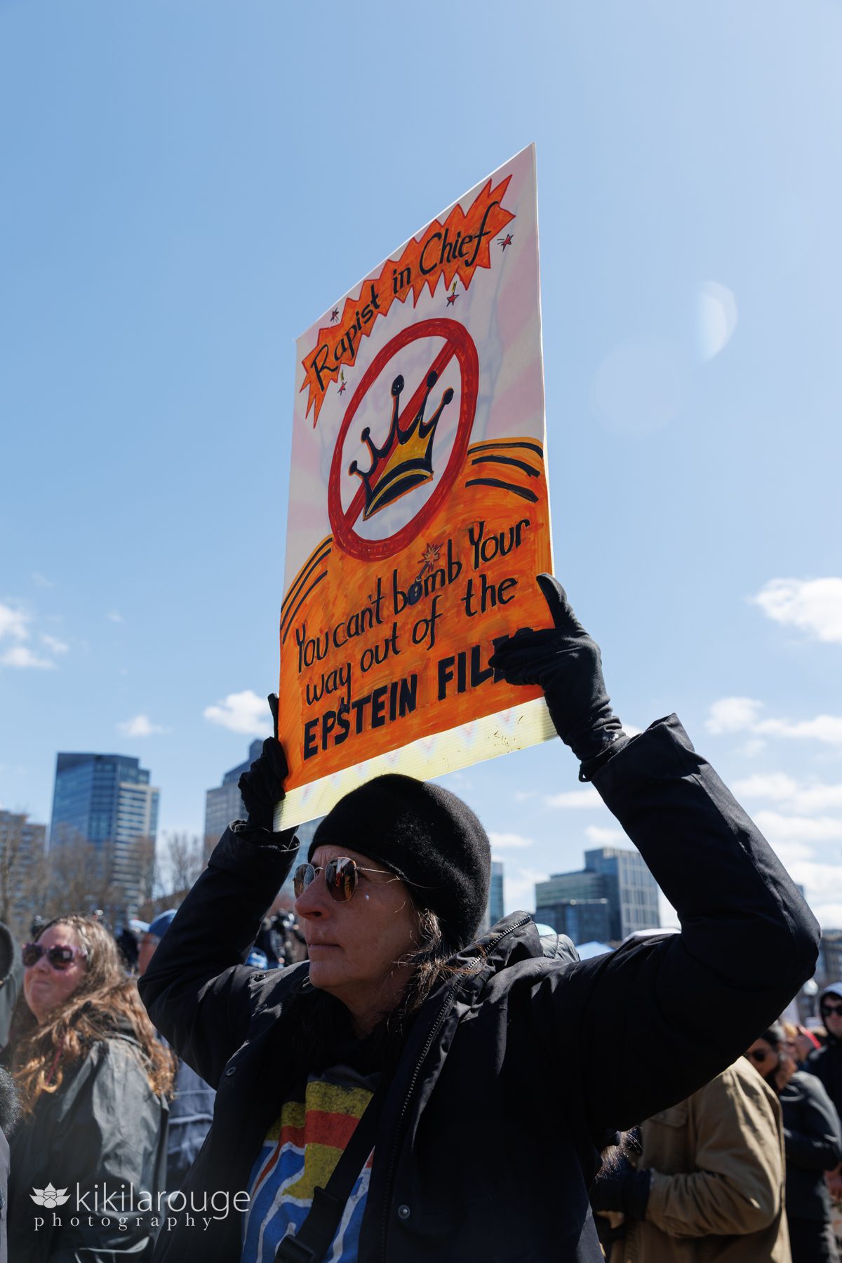 Bright orange protest sign being held up at No Kings Anti trump Rally on the Boston common 