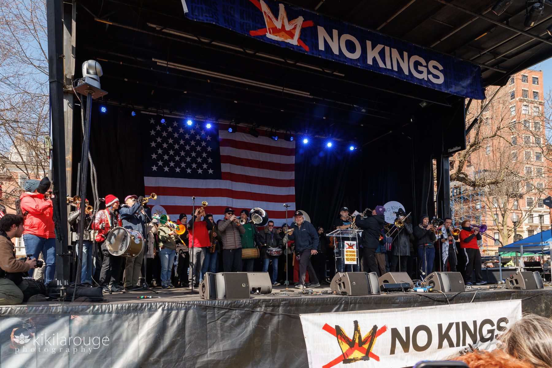 Large marching band on stage at the No Kings rally in Boston Massachusetts