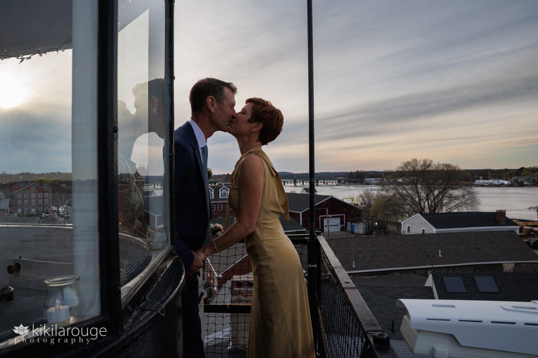 Sunset kiss at elopement with reflection atop the NBPT lighthouse. 