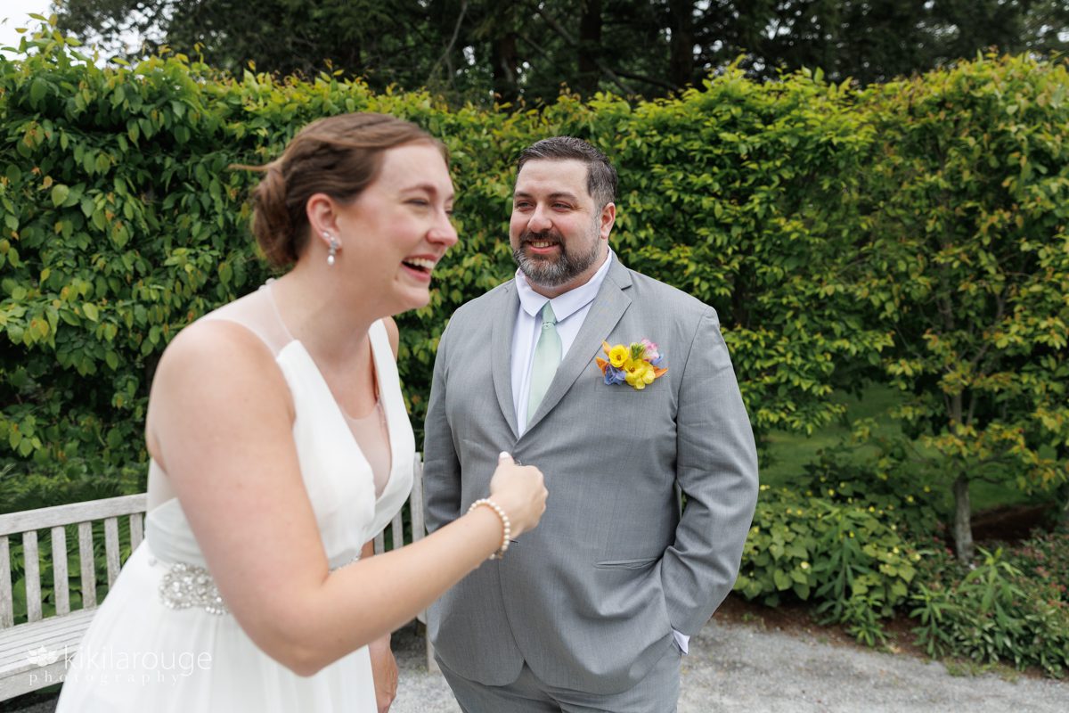 Wedding couple after reading private vows bride out of focus laughing and groom in focus in back smiling 