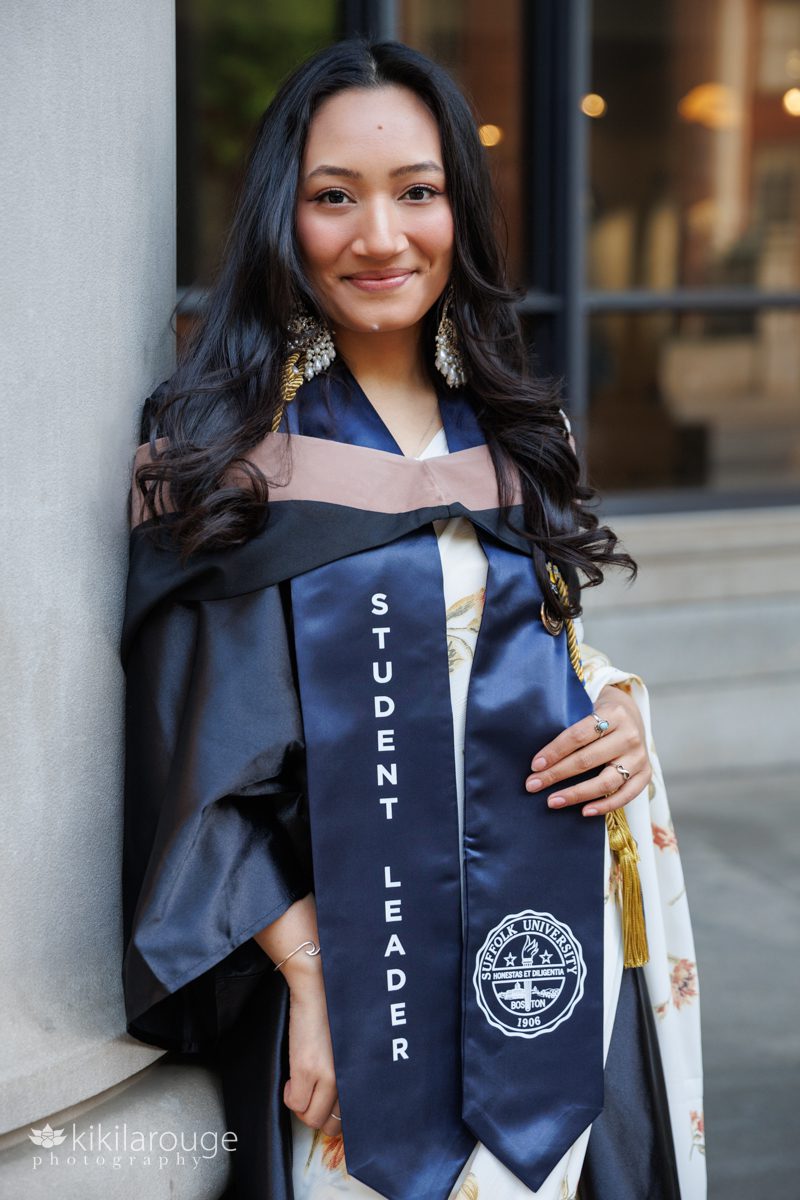 College graduate from Suffolk University with there graduation stole and gown wearing a beautiful floral sari 